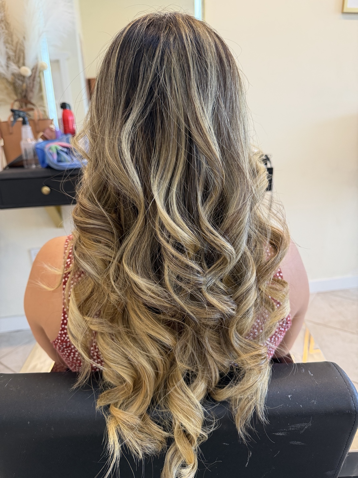 Highlighted blonde curls after salon service